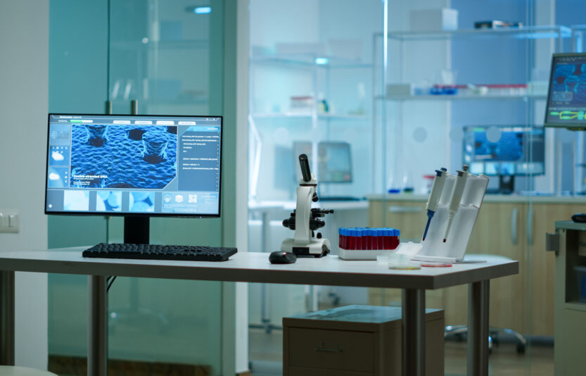 Modern empty biological applied science laboratory Modern empty biological applied science laboratory with technological microscopes, glass test tubes, micropipettes, desktop computers and displays. PC's are running sophisticated DNA calculations.